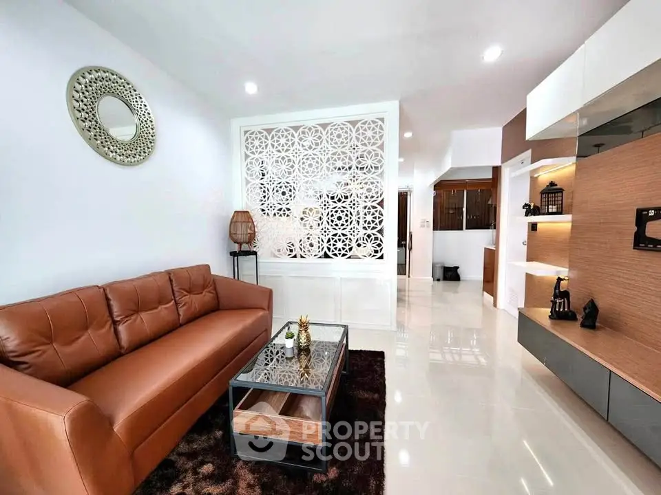 Modern living room with stylish decor and leather sofa in a contemporary apartment.