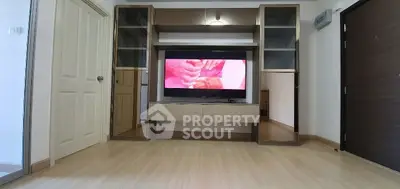 Modern living room with built-in TV unit and wooden flooring