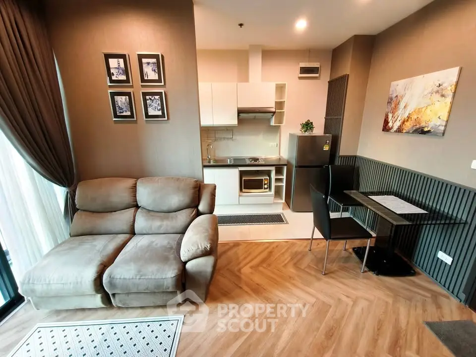 Modern open-plan living room and kitchen with cozy sofa and dining area