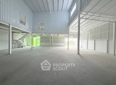 Spacious industrial warehouse with high ceilings and mezzanine level.