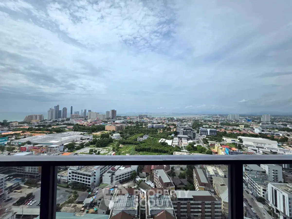 Stunning panoramic cityscape view from a high-rise balcony, showcasing urban skyline and lush greenery.