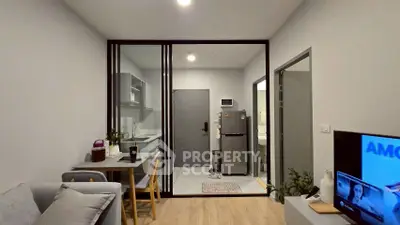 Modern open-plan living room with kitchen and dining area, featuring sleek design and cozy ambiance.