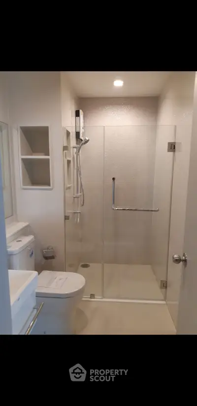 Modern bathroom with glass shower enclosure and sleek fixtures