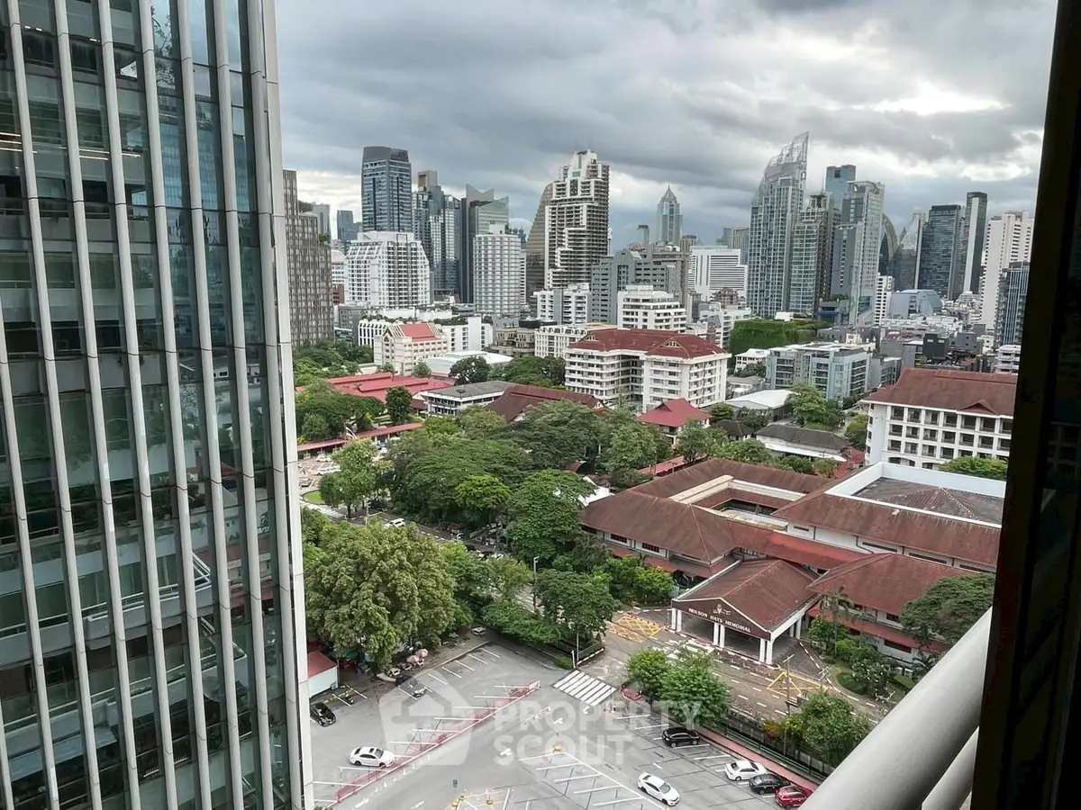 Stunning cityscape view from high-rise building balcony in urban area.