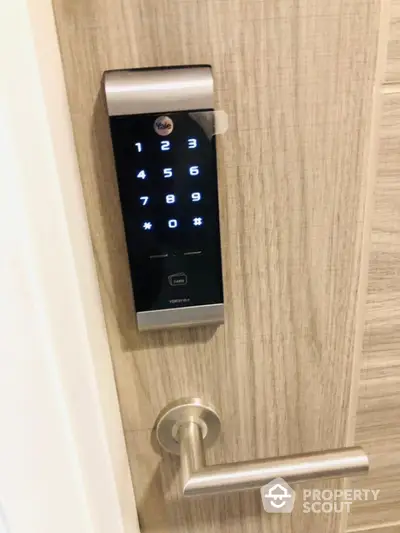 Modern digital door lock on wooden door with sleek handle, enhancing security and style in contemporary homes.