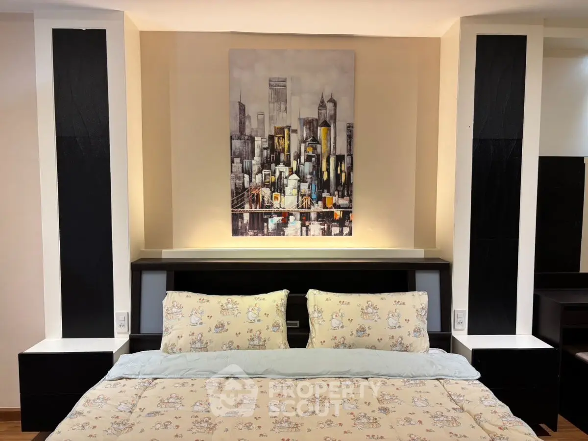 Cozy bedroom with stylish cityscape artwork and elegant bedding