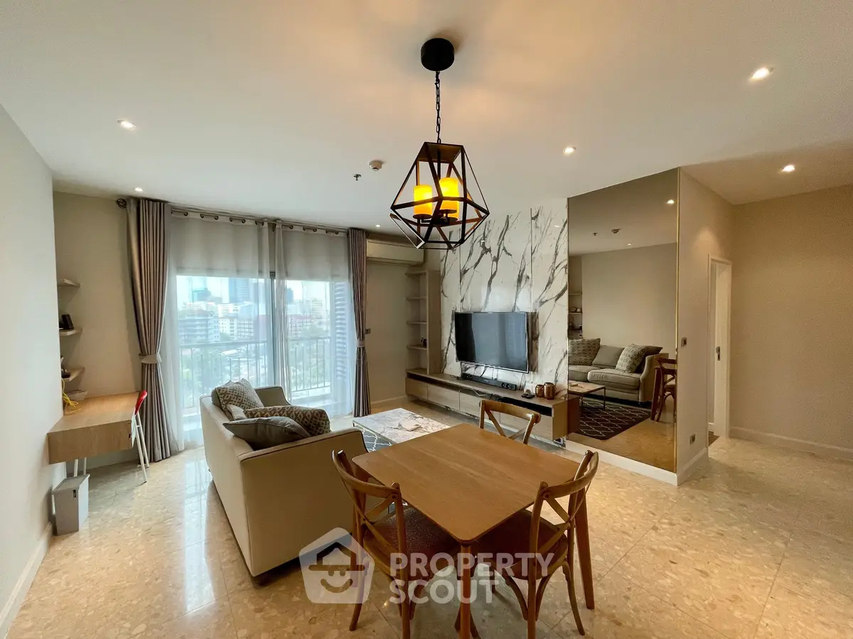 Spacious modern living room with elegant decor and city view, featuring a cozy seating area and stylish dining set.