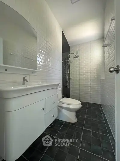 Modern bathroom with sleek white fixtures and stylish tile design