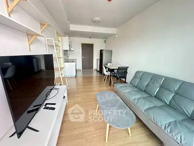 Modern living room with sleek furniture and open kitchen layout in a stylish apartment.