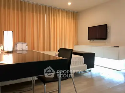 Modern living room with sleek furniture and wall-mounted TV