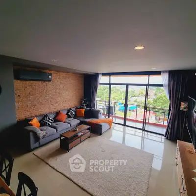 Spacious living room with modern decor and large windows offering a scenic view.
