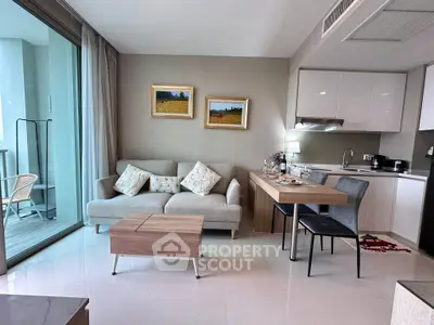 Modern open-plan living room with cozy sofa and sleek kitchen area