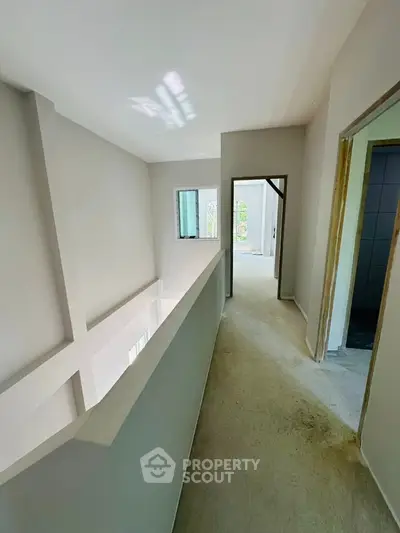 Spacious hallway with modern design and natural light in a contemporary home