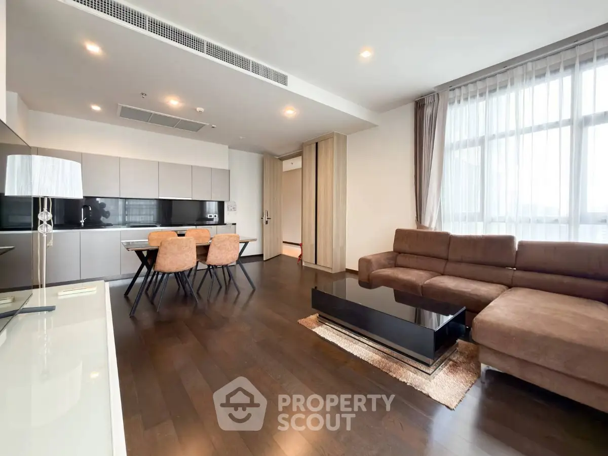 Spacious modern living room with open kitchen and elegant furnishings