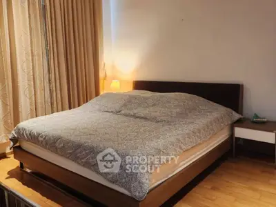 Cozy bedroom with elegant wooden flooring and ambient lighting