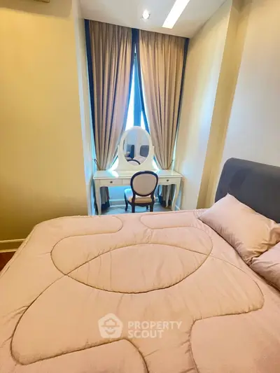 Cozy bedroom with elegant vanity and plush bedding in modern apartment