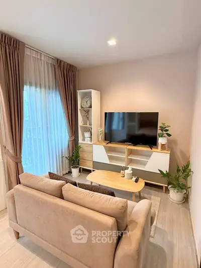 Cozy living room with modern decor, featuring a plush sofa, sleek TV stand, and elegant curtains.
