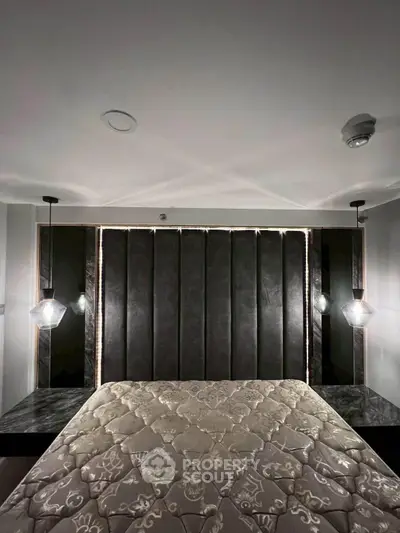 Luxurious bedroom with elegant lighting and plush bedding