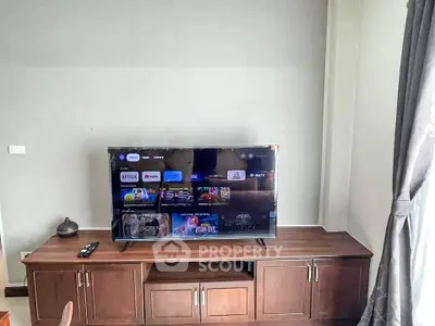 Modern living room with sleek TV setup and elegant wooden cabinet