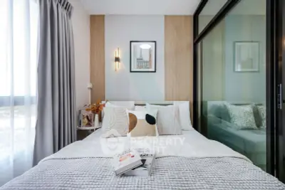 Modern bedroom with stylish decor and cozy bedding in a contemporary apartment.