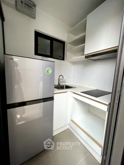 Modern compact kitchen with sleek appliances and minimalist design