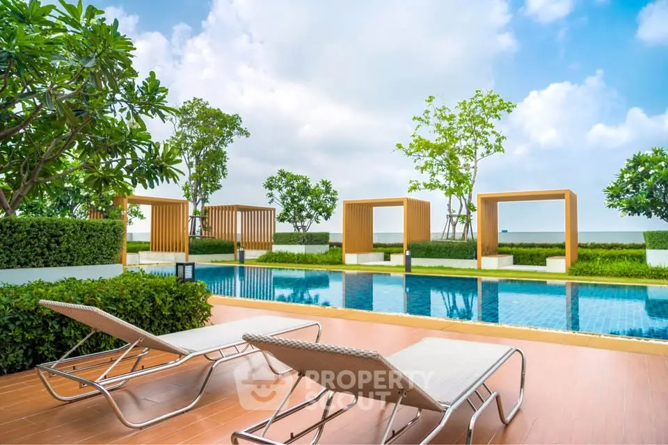 Luxurious outdoor pool area with stylish loungers and modern landscaping.