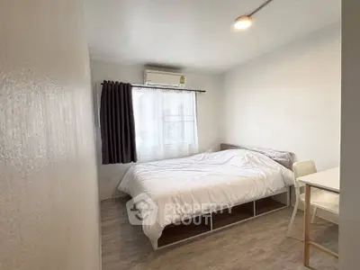 Cozy minimalist bedroom with natural light and modern furnishings