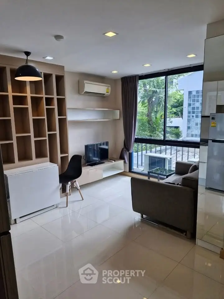 Modern living room with large windows and stylish furniture in a contemporary apartment.