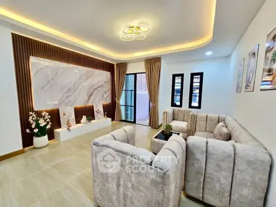 Luxurious modern living room with elegant lighting and plush sofas, perfect for relaxation and entertainment.