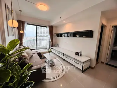 Modern living room with stylish decor and city view, featuring a cozy sofa and sleek entertainment unit.