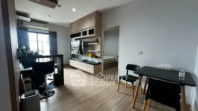 Modern studio apartment with open layout, featuring a cozy living area and stylish kitchen.