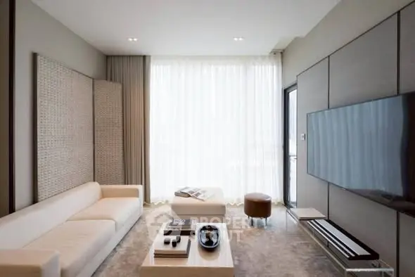 Modern living room with sleek design, large TV, and natural light from floor-to-ceiling windows.