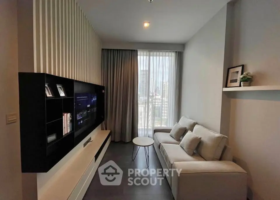 Modern living room with sleek TV unit and cozy sofa in a stylish apartment