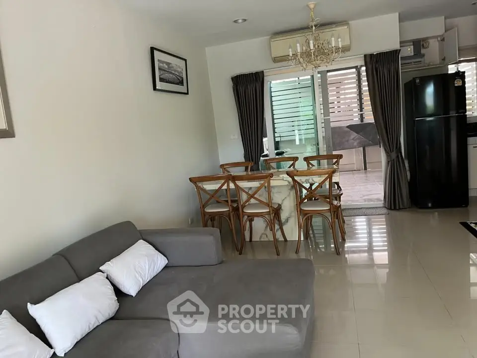 Modern living room with elegant dining area and open kitchen layout.