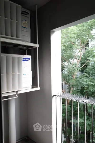 Modern balcony with air conditioning units and lush green view