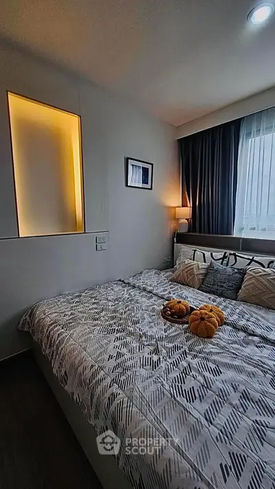 Cozy bedroom with modern decor and ambient lighting, perfect for relaxation.