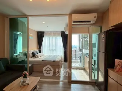 Modern apartment interior with bedroom, living area, and balcony view.