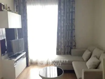 Cozy living room with modern sofa and entertainment center, perfect for relaxation.