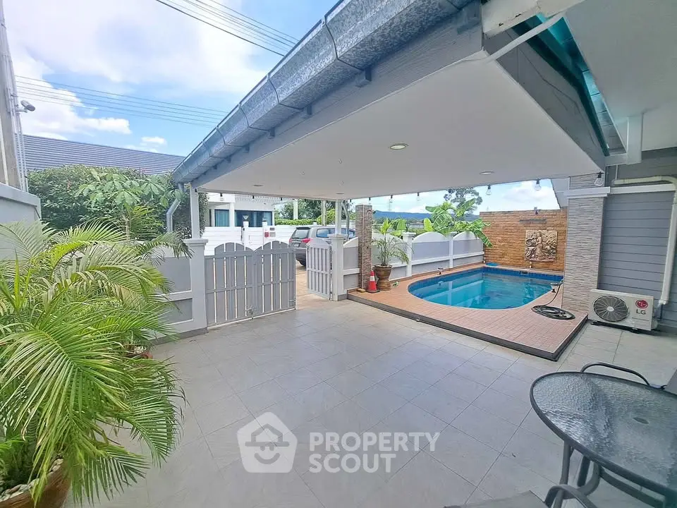 Spacious patio with pool and garden, perfect for outdoor relaxation.