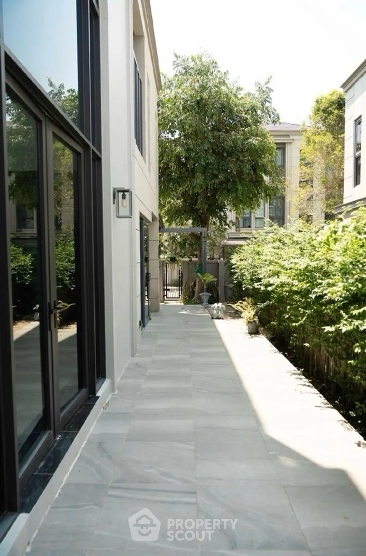 Modern exterior walkway with lush greenery and sleek design