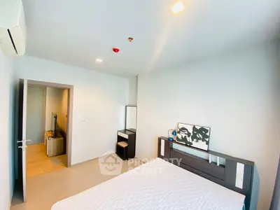 Modern bedroom with minimalist decor and ample natural light