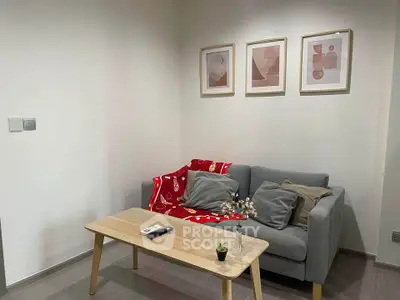 Cozy living room with modern decor, featuring a comfortable sofa, stylish coffee table, and framed art on the wall.