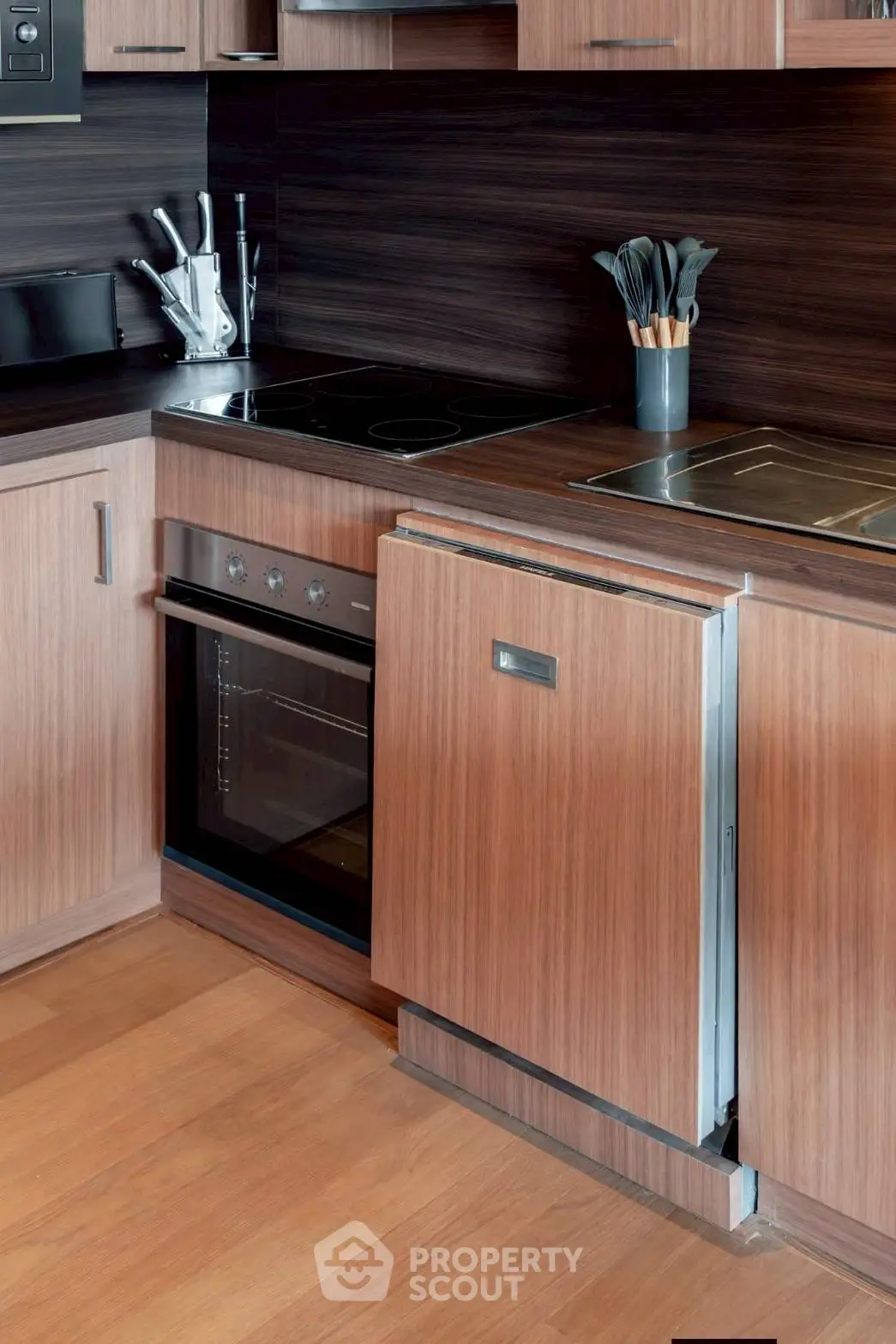 Modern kitchen with sleek wooden cabinetry and built-in appliances