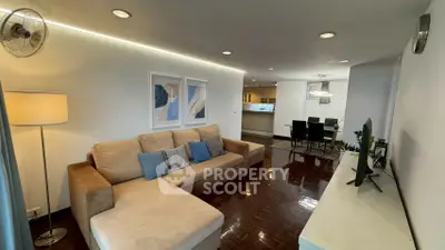 Spacious living room with modern decor and open dining area, perfect for entertaining guests.