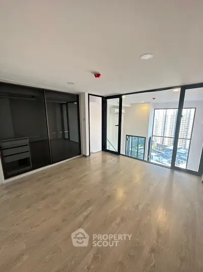 Spacious modern apartment with floor-to-ceiling windows and city view
