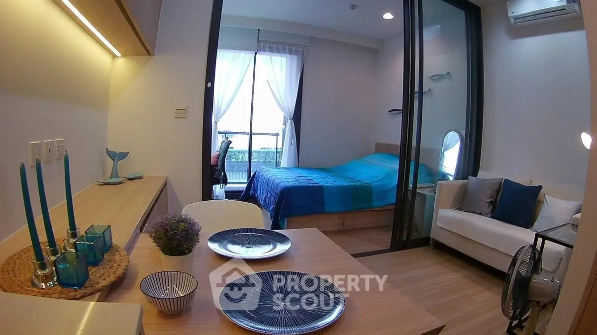 Modern studio apartment with cozy bedroom and stylish dining area