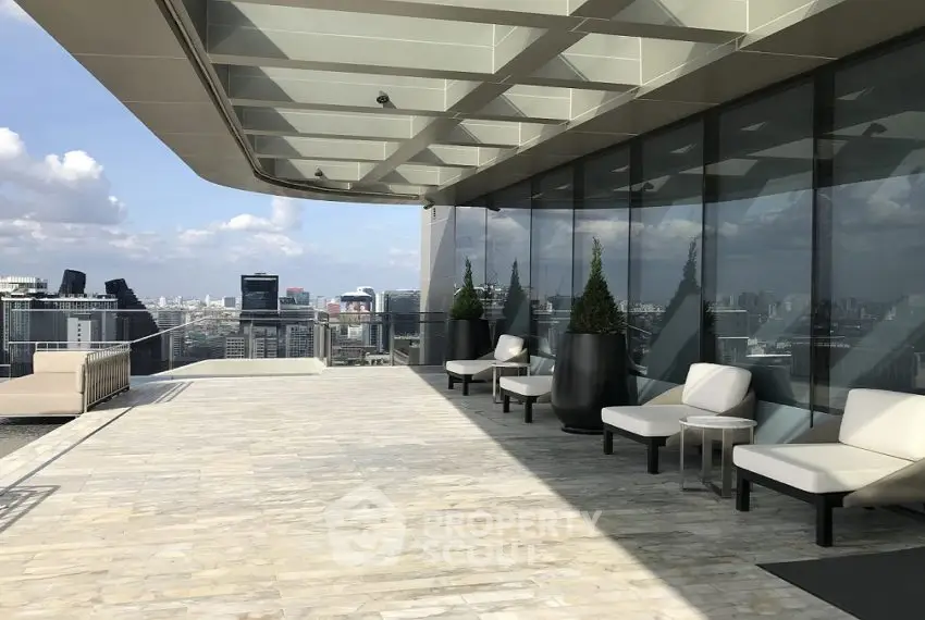 Luxurious rooftop terrace with stunning city skyline views and modern seating area.