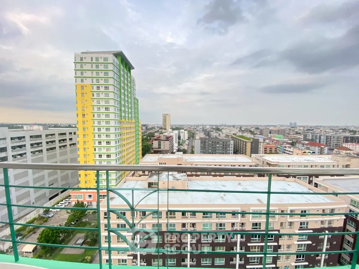 Stunning cityscape view from high-rise balcony showcasing urban skyline and modern architecture.