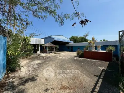 Spacious industrial property with open courtyard and unique outdoor features.