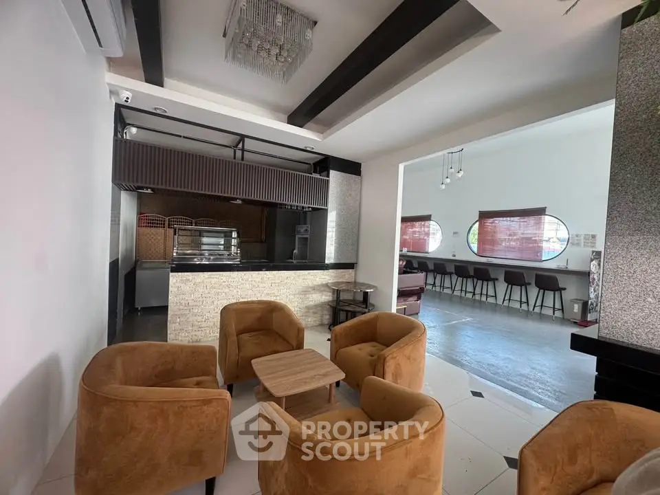Spacious modern living area with stylish seating and open layout, perfect for entertaining guests.